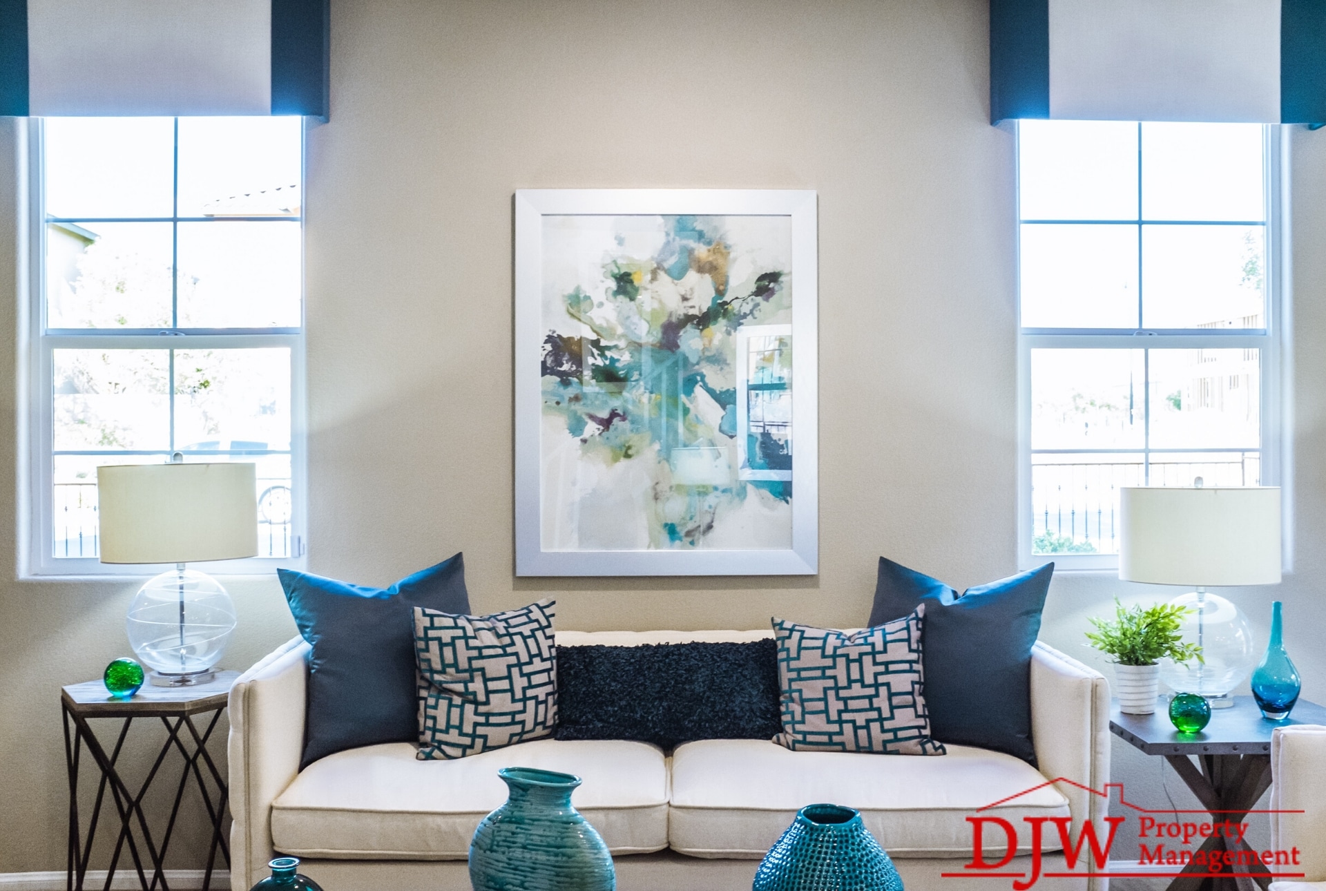 A white living room with teal and green accents.